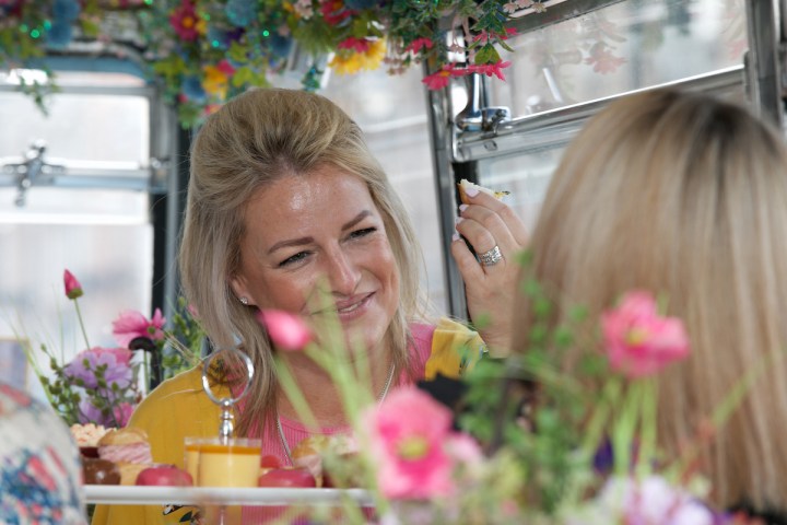 a woman standing in front of a mirror posing for the camera