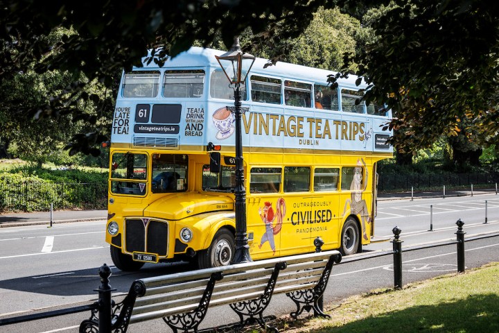 a double decker bus driving down a street