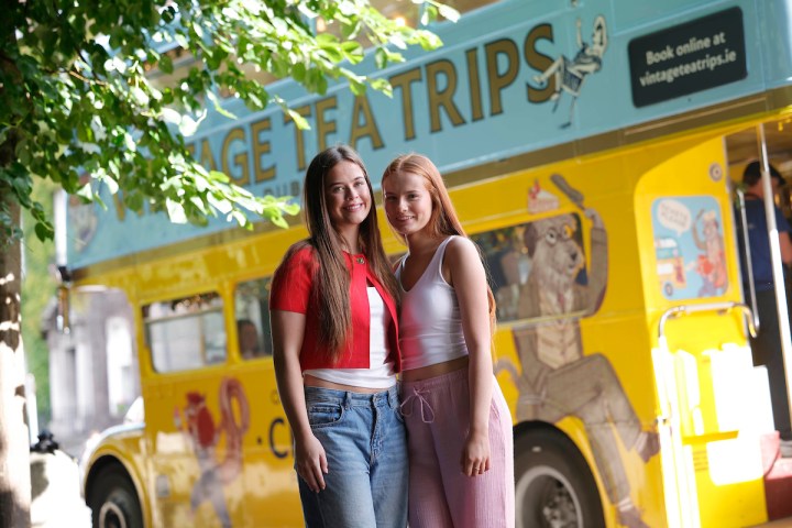 a woman standing in front of a bus