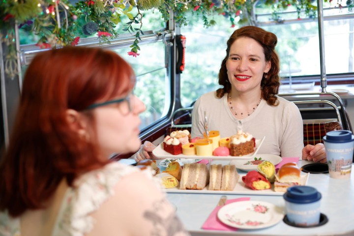 a woman sitting at a table with a cake