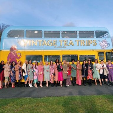 a group of people standing in front of a bus