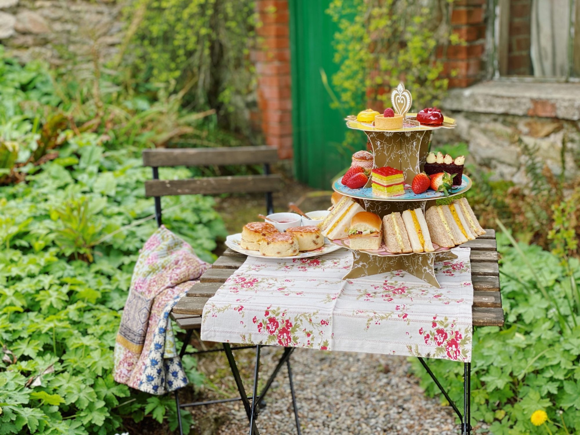 a table set up outdoors with afternoon tea