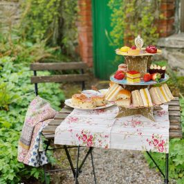 a table set up outdoors with afternoon tea