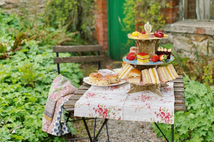 a table set up outdoors with afternoon tea