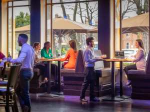 a group of people sitting in front of a window