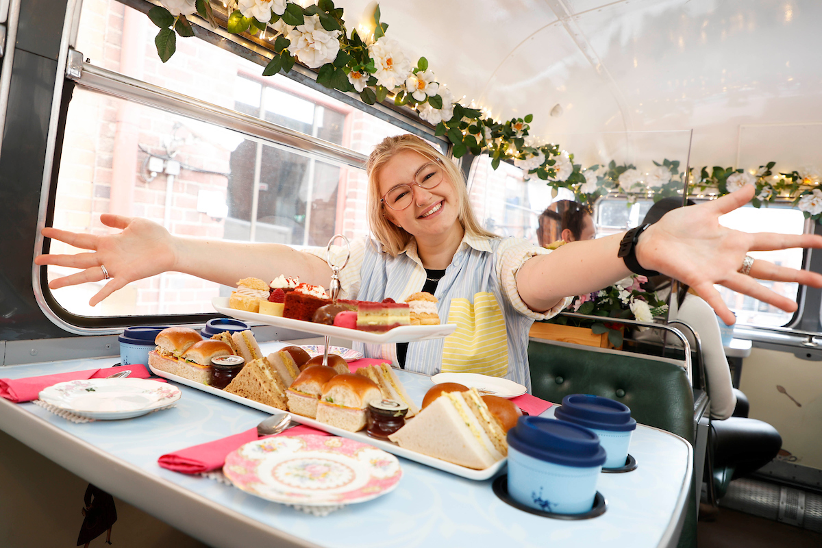 a woman sitting at a table with a plate of food