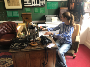 a person sitting on a chair in front of a desk