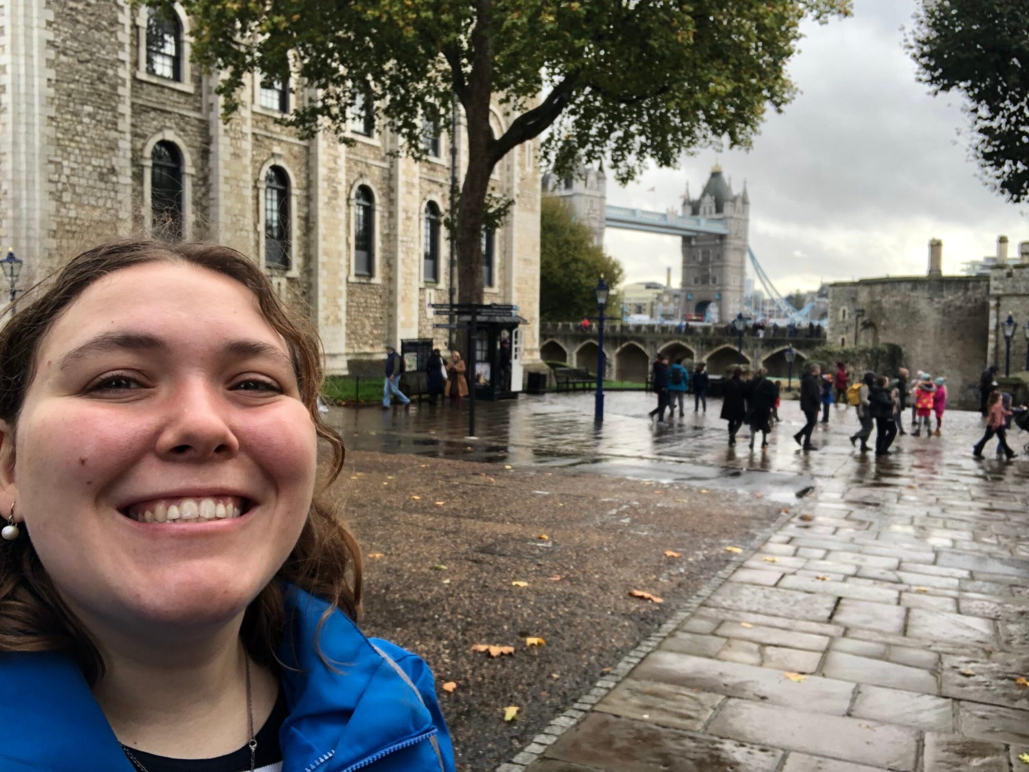 a person smiling in front of a building