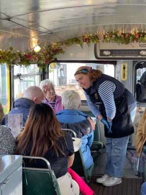 a group of people sitting in a chair talking on a cell phone