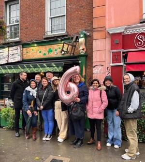 a group of people posing in front of a building