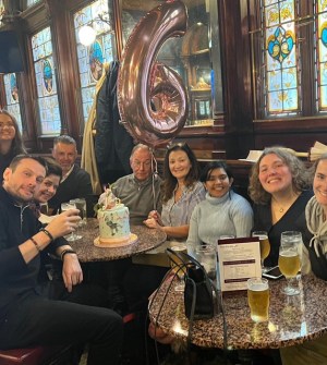 a group of people sitting at a table posing for the camera