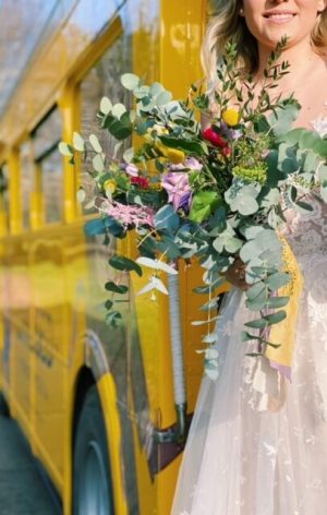 a woman standing in front of a flower
