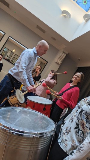 a group of people standing around a table