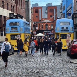 a group of people walking on a city street