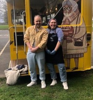 a person standing in front of a bus