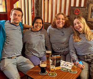 a group of people sitting at a table posing for the camera