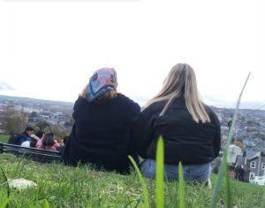 a group of people sitting in the grass