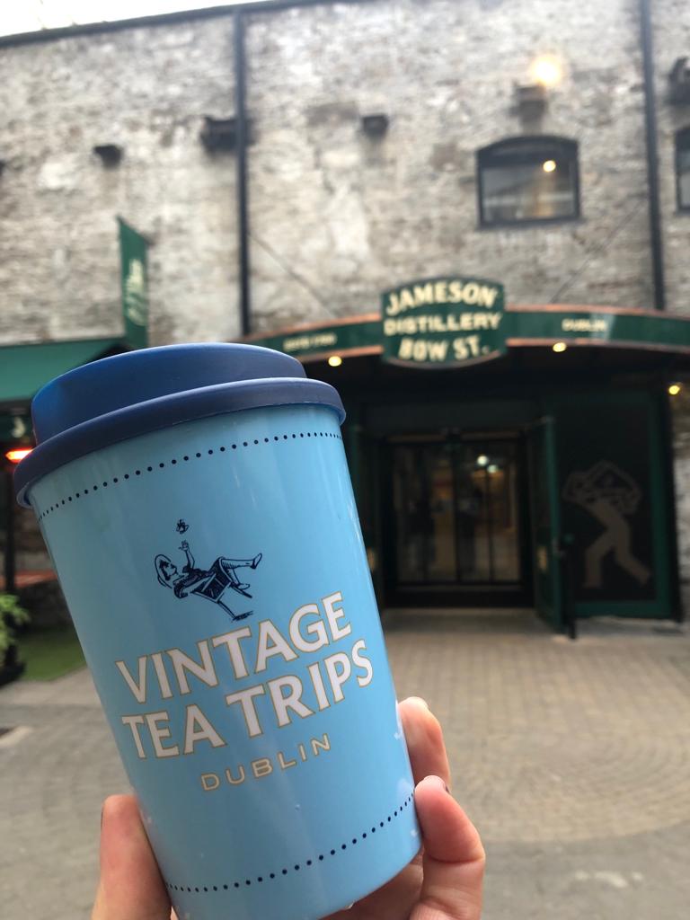 a person holding a cup of coffee