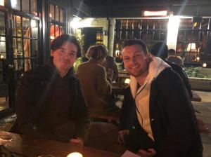 a group of people standing in front of a restaurant
