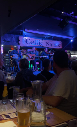 a group of people sitting at a table in a restaurant