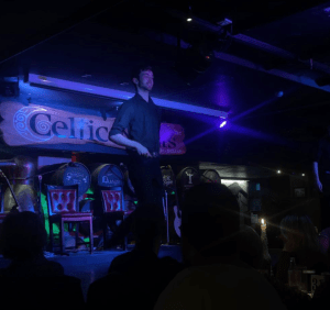 a person standing on a stage in front of a crowd