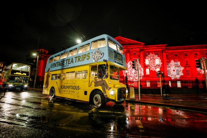 a bus that is parked on a rainy night