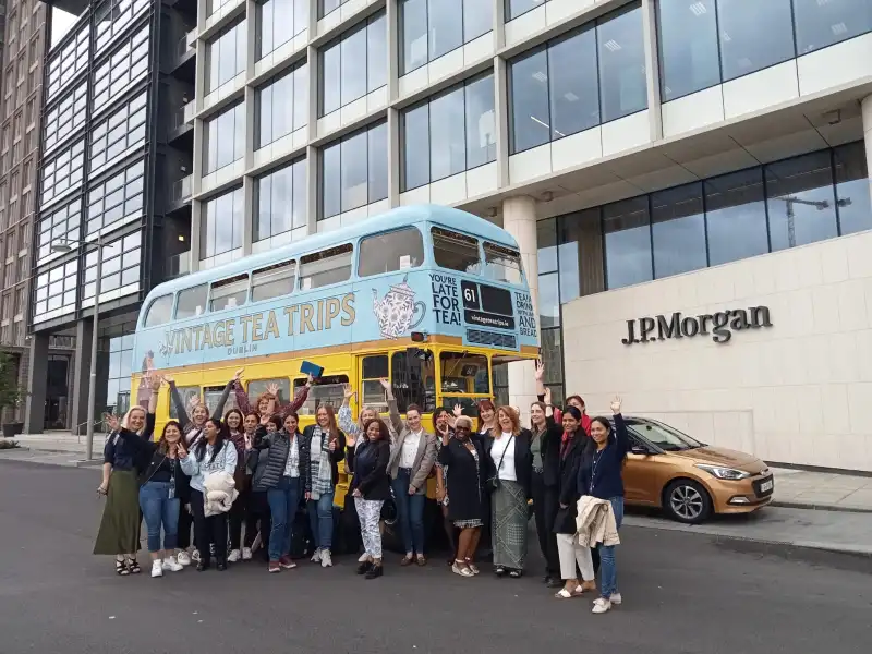 corporate events vintage tea trips a group of people standing in front of a building