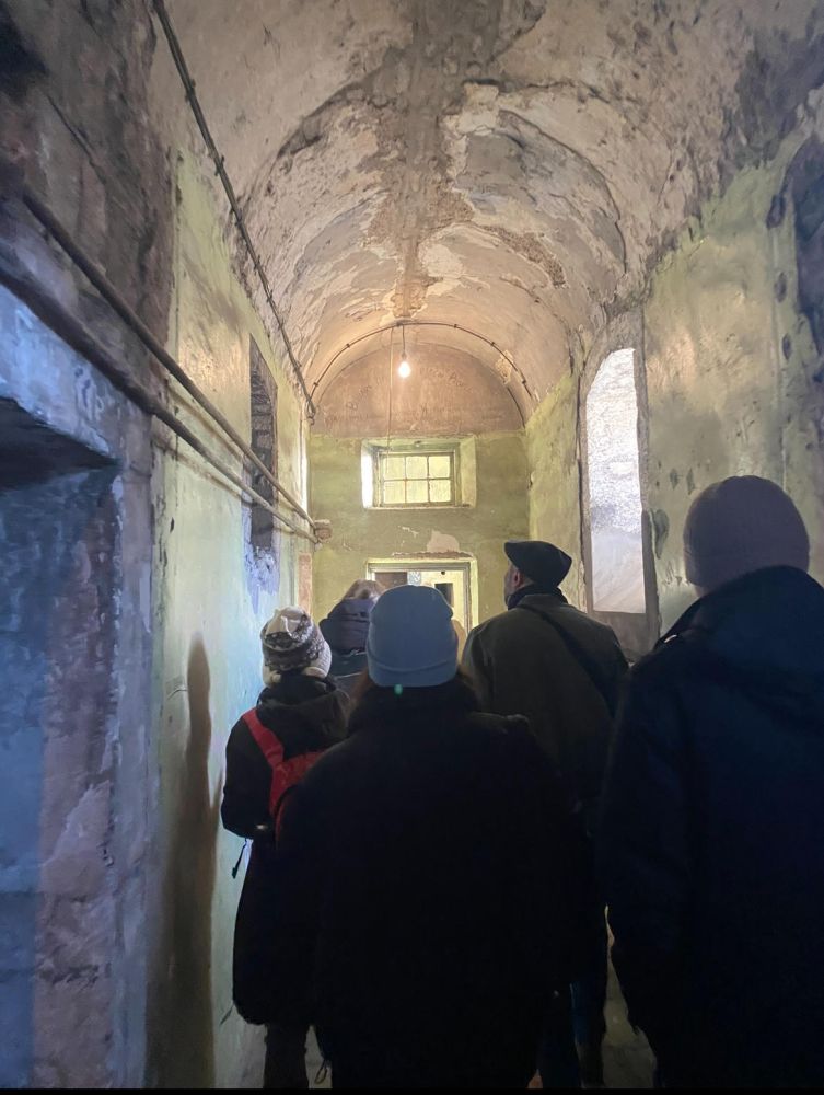 a group of people standing in Kilmainham Jail