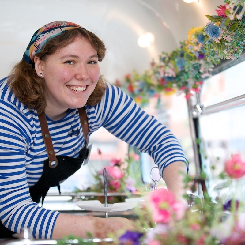 a woman standing in front of a cake