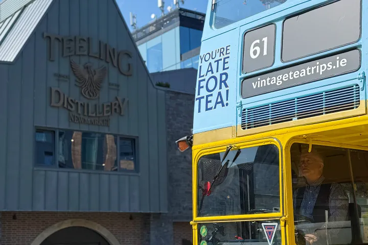 vintage tea trips bus parked in front of teeling whiskey distillery