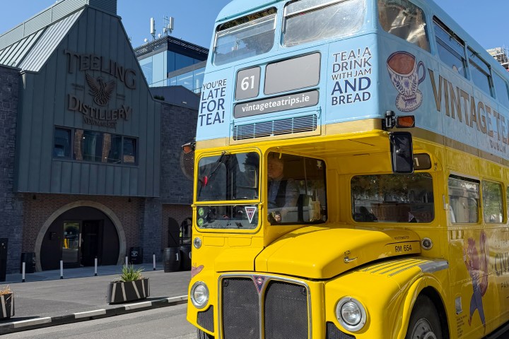 vintage tea trips bus parked in front of teeling whiskey distillery