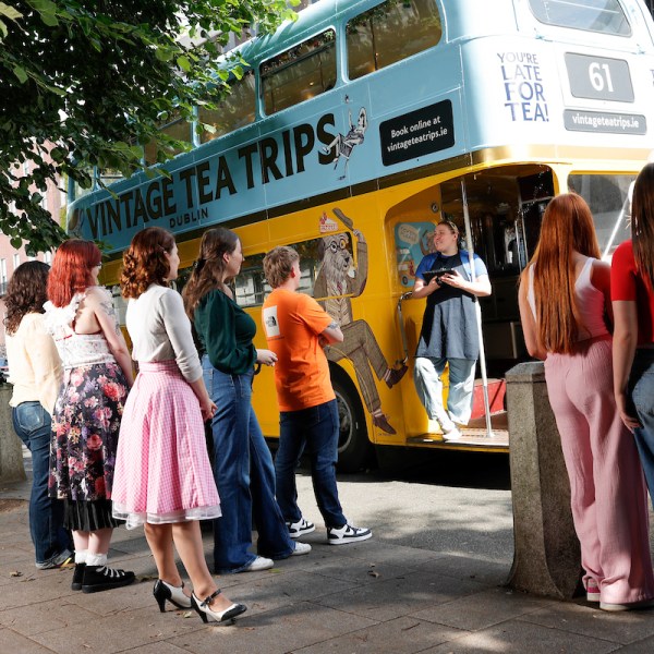 a group of people standing in front of a bus