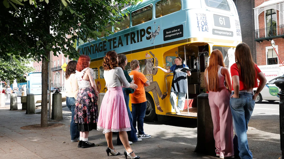 a group of people standing in front of a bus