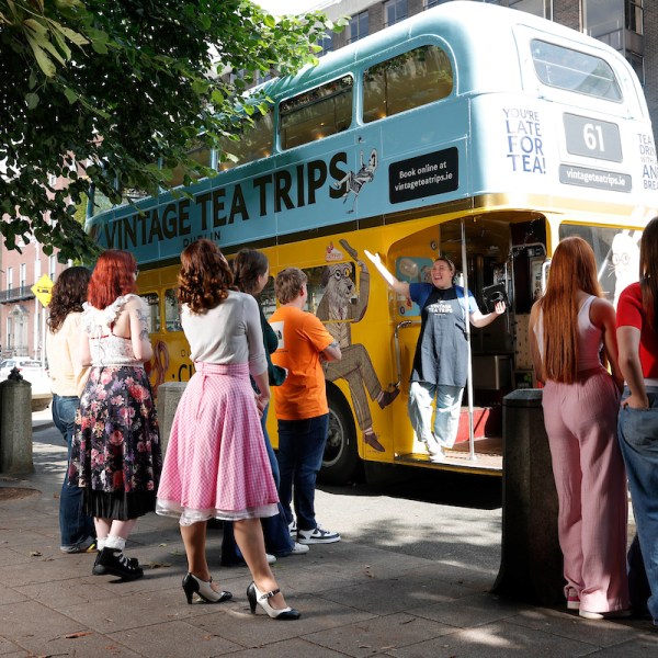 a group of people standing in front of a bus