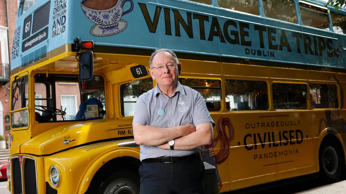 a man standing in front of a bus