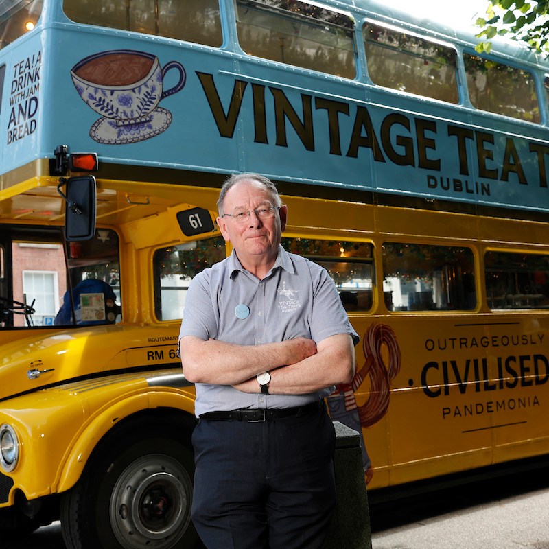 a man standing in front of a bus