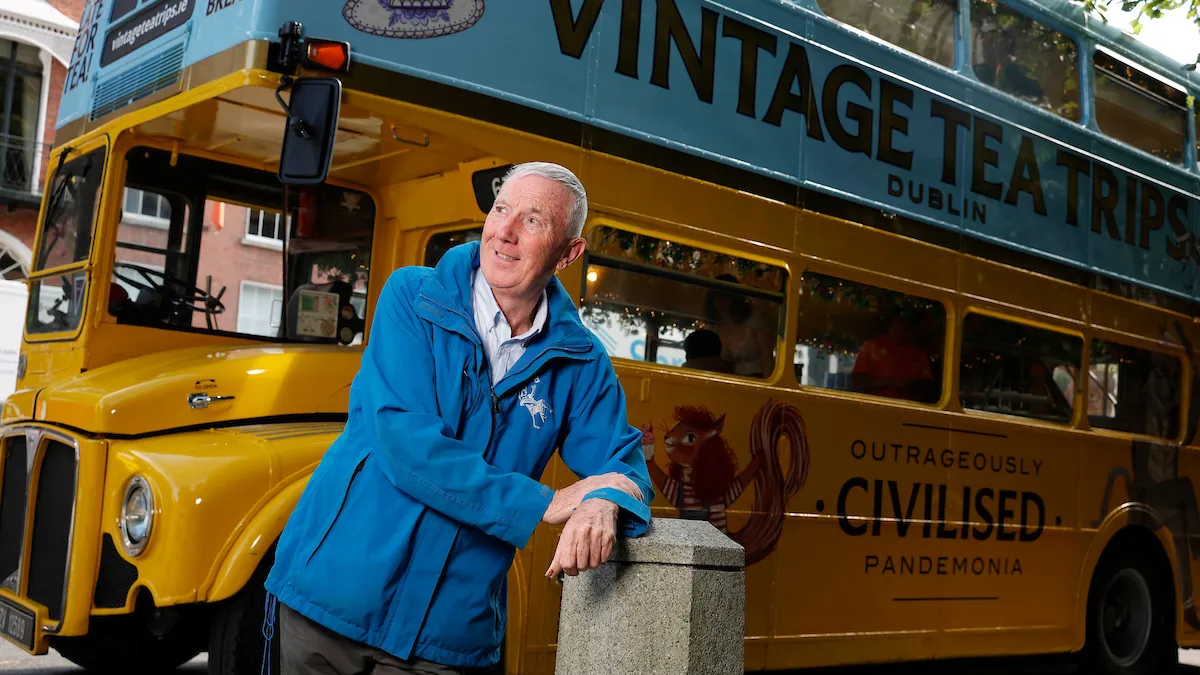 a man standing in front of a bus