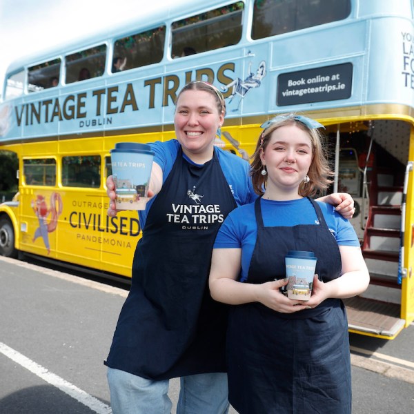a person standing in front of a bus