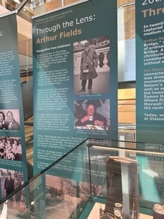 Exhibit panels featuring Arthur Fields' photography with historical photos and text.