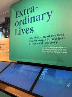 Exhibit titled 'Extraordinary Lives' with digital displays at Glasnevin Cemetery.