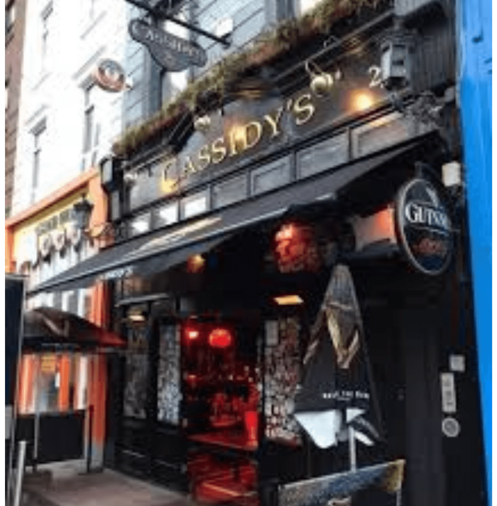 Exterior of Cassidy's pub with black and gold signage, open entrance, and Guinness branding.