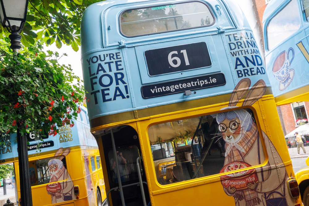 Vintage double-decker bus with tea-themed ads, featuring a cartoon rabbit.